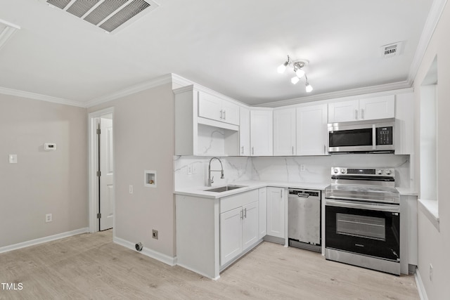 2705 Crest St Unit 3, Durham, NC 27705 - kitchen featuring stainless steel appliances, light wood finished floors, ornamental molding, light countertops, and decorative backsplash