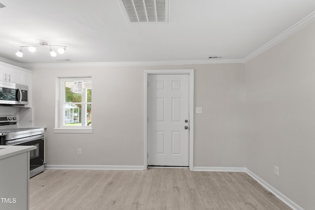 2705 Crest St Unit 3, Durham, NC 27705 - kitchen featuring appliances with stainless steel finishes, light wood finished floors, crown molding, light countertops, and white cabinets