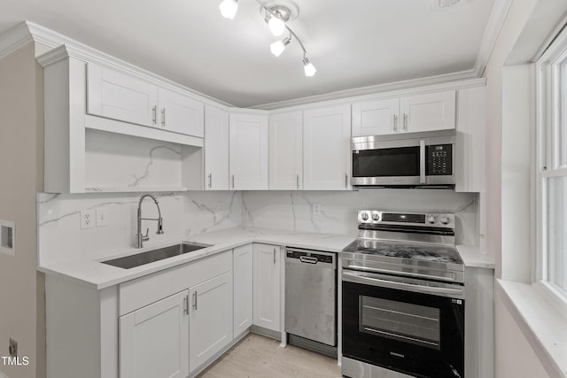 2705 Crest St Unit 3, Durham, NC 27705 - kitchen featuring stainless steel appliances, white cabinets, light wood finished floors, decorative backsplash, and light stone countertops
