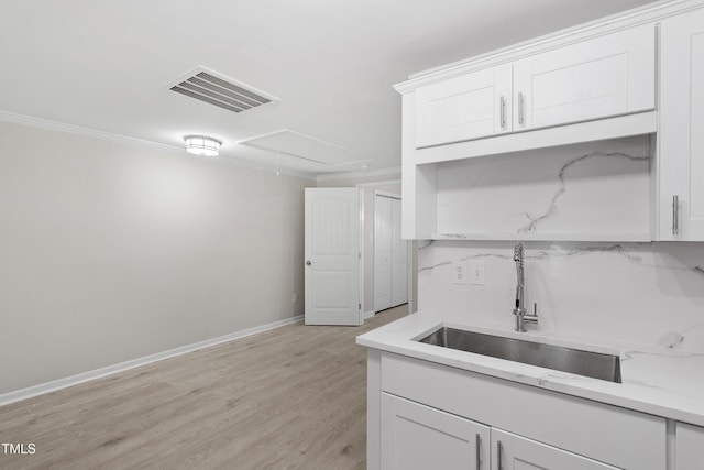 2705 Crest St Unit 3, Durham, NC 27705 - kitchen featuring white cabinets, light wood-style flooring, and ornamental molding