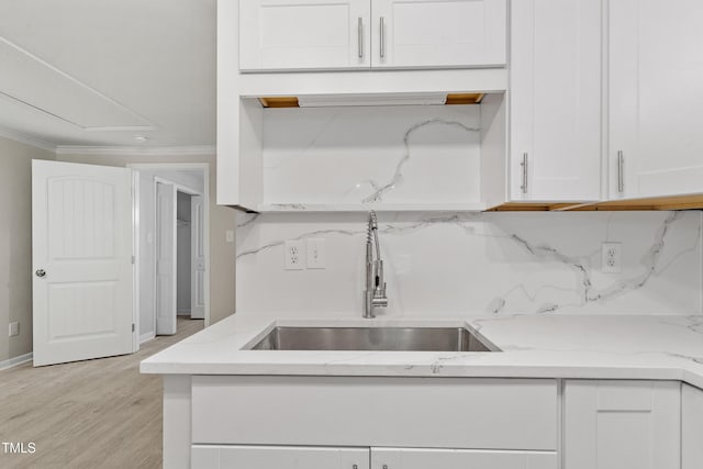 2705 Crest St Unit 3, Durham, NC 27705 - kitchen with white cabinetry, light wood-style flooring, ornamental molding, and light stone counters