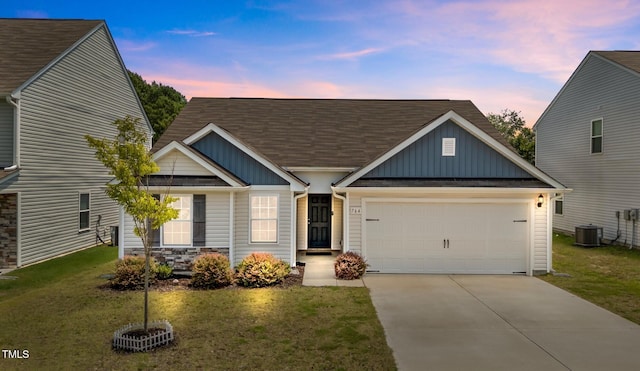 764 Frosty Way, Zebulon, NC 27597 - view of front facade with board and batten siding, driveway, an attached garage, a yard, and roof with shingles