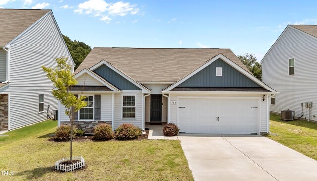 764 Frosty Way, Zebulon, NC 27597 - view of front of property featuring board and batten siding, a garage, driveway, a front yard, and a shingled roof