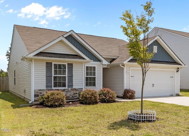 764 Frosty Way, Zebulon, NC 27597 - view of front of home with board and batten siding, driveway, an attached garage, and a front yard