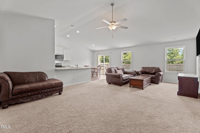 764 Frosty Way, Zebulon, NC 27597 - living area featuring vaulted ceiling, a ceiling fan, and light carpet