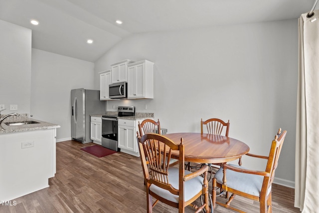 764 Frosty Way, Zebulon, NC 27597 - dining space with lofted ceiling, dark wood finished floors, and recessed lighting