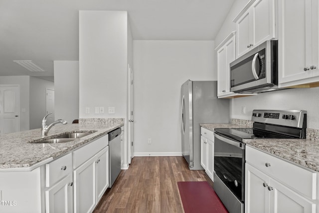 764 Frosty Way, Zebulon, NC 27597 - kitchen with appliances with stainless steel finishes, a peninsula, dark wood finished floors, and white cabinets