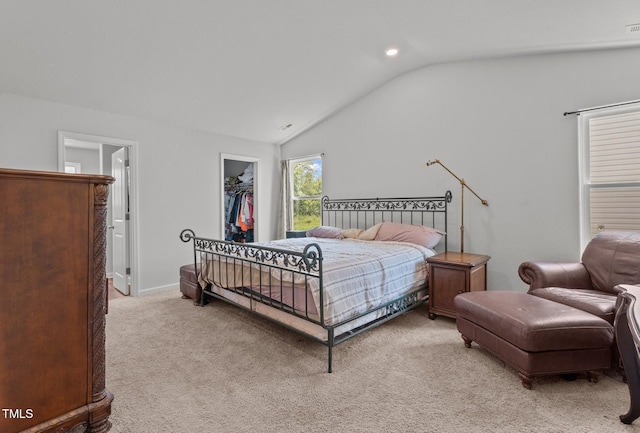 764 Frosty Way, Zebulon, NC 27597 - bedroom with lofted ceiling, a walk in closet, light carpet, and recessed lighting