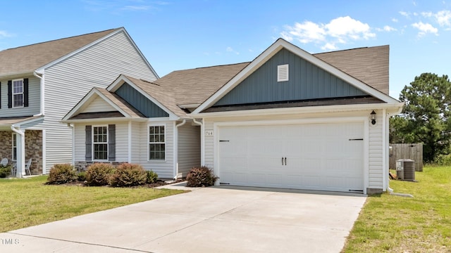 764 Frosty Way, Zebulon, NC 27597 - view of front facade with board and batten siding, a front yard, driveway, and a garage
