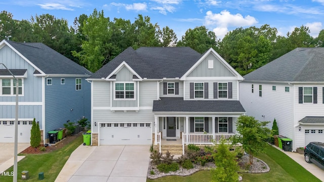 425 Cahors Trl, Holly Springs, NC 27540 - view of front facade with board and batten siding, covered porch, driveway, roof with shingles, and a garage