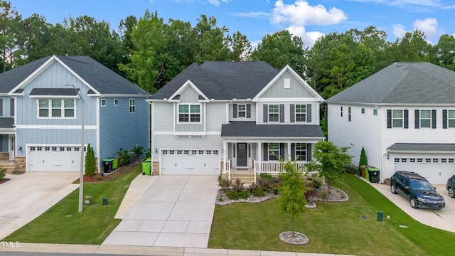 425 Cahors Trl, Holly Springs, NC 27540 - view of front facade with board and batten siding, a porch, driveway, an attached garage, and stone siding
