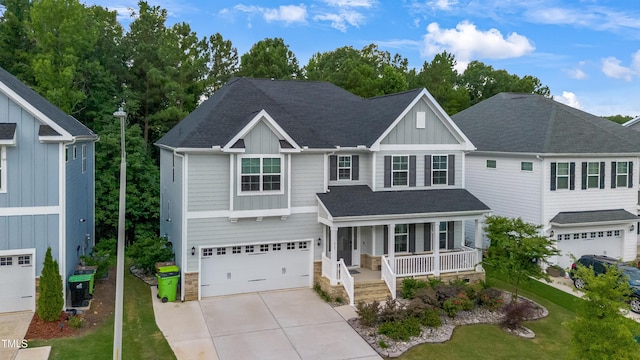 425 Cahors Trl, Holly Springs, NC 27540 - view of front of home with a porch, board and batten siding, an attached garage, driveway, and a shingled roof