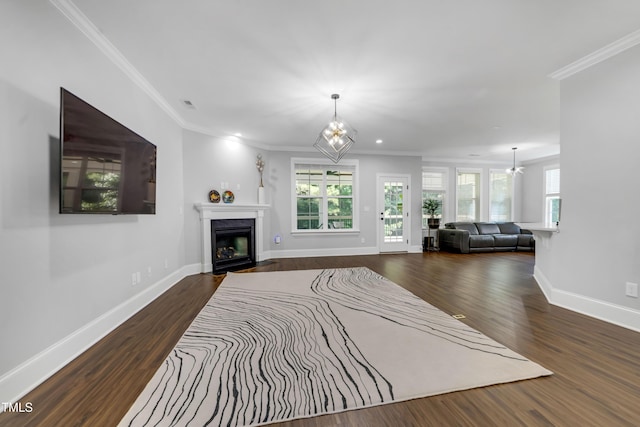425 Cahors Trl, Holly Springs, NC 27540 - living room featuring a chandelier, wood finished floors, a fireplace with flush hearth, crown molding, and recessed lighting
