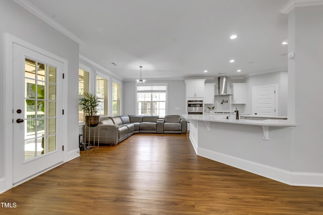 425 Cahors Trl, Holly Springs, NC 27540 - living area featuring dark wood finished floors, crown molding, and recessed lighting