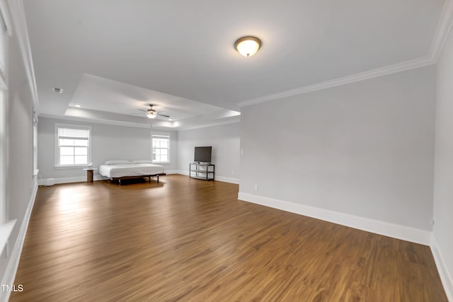 425 Cahors Trl, Holly Springs, NC 27540 - unfurnished living room with a raised ceiling, ornamental molding, wood finished floors, and a ceiling fan