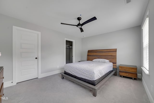425 Cahors Trl, Holly Springs, NC 27540 - bedroom featuring carpet flooring, multiple windows, a ceiling fan, and a walk in closet