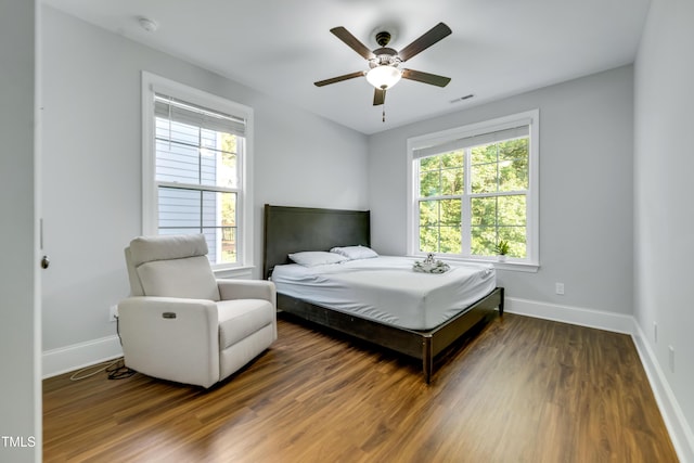 425 Cahors Trl, Holly Springs, NC 27540 - bedroom featuring multiple windows, wood finished floors, and a ceiling fan
