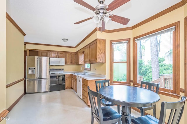 3008 Sgt Pepper Ct, Raleigh, NC 27603 - kitchen featuring white appliances, light countertops, crown molding, a ceiling fan, and brown cabinets