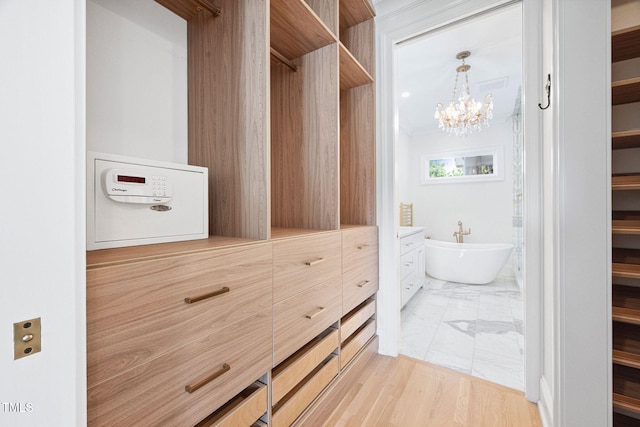 781 Crabtree Crossing Pkwy, Cary, NC 27513 - walk in closet with a chandelier and light marble finish floors
