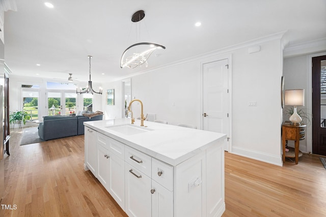 781 Crabtree Crossing Pkwy, Cary, NC 27513 - kitchen featuring a chandelier, open floor plan, crown molding, light wood finished floors, and recessed lighting
