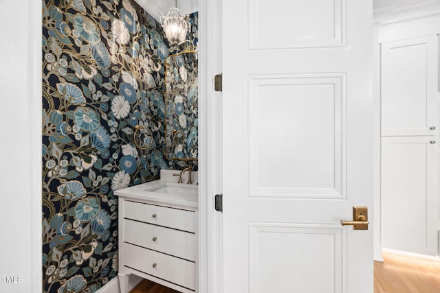 781 Crabtree Crossing Pkwy, Cary, NC 27513 - bathroom with vanity, wallpapered walls, and wood finished floors