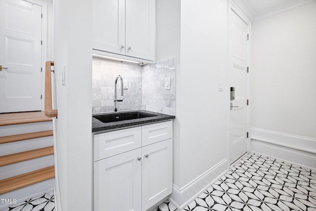 781 Crabtree Crossing Pkwy, Cary, NC 27513 - kitchen featuring tasteful backsplash, white cabinetry, dark stone counters, light floors, and ornamental molding