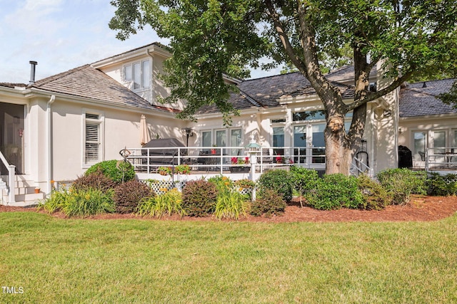 781 Crabtree Crossing Pkwy, Cary, NC 27513 - rear view of house featuring stucco siding, a yard, and a deck