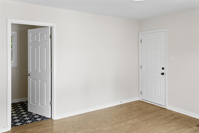 310 E Pilot St, Durham, NC 27707 - spare room featuring baseboards and wood finished floors