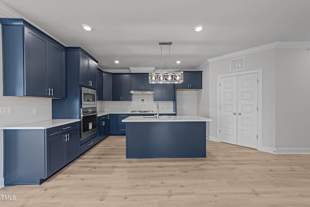 1400 Gathering Park Cir Unit 302, Cary, NC 27519 - kitchen with appliances with stainless steel finishes, crown molding, light countertops, under cabinet range hood, and blue cabinetry