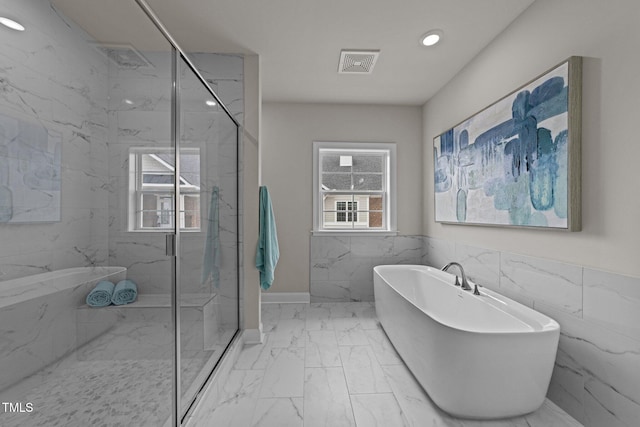 1400 Gathering Park Cir Unit 302, Cary, NC 27519 - full bath featuring marble look tile flooring, a marble finish shower, recessed lighting, a soaking tub, and wainscoting