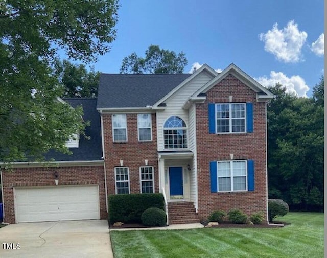 902 Savannah Ct, Hillsborough, NC 27278 - view of front of house featuring concrete driveway, a garage, a front lawn, and brick siding