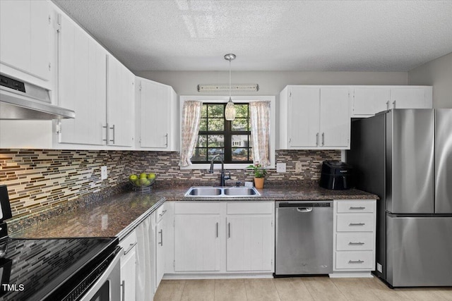 18 Willow Bridge Dr, Durham, NC 27707 - kitchen featuring appliances with stainless steel finishes, white cabinetry, dark countertops, ventilation hood, and a textured ceiling