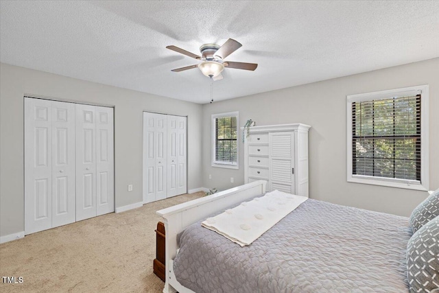 18 Willow Bridge Dr, Durham, NC 27707 - carpeted bedroom featuring multiple closets, a textured ceiling, and ceiling fan
