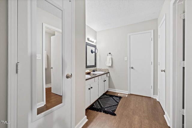 18 Willow Bridge Dr, Durham, NC 27707 - bathroom with wood finished floors, vanity, and a textured ceiling