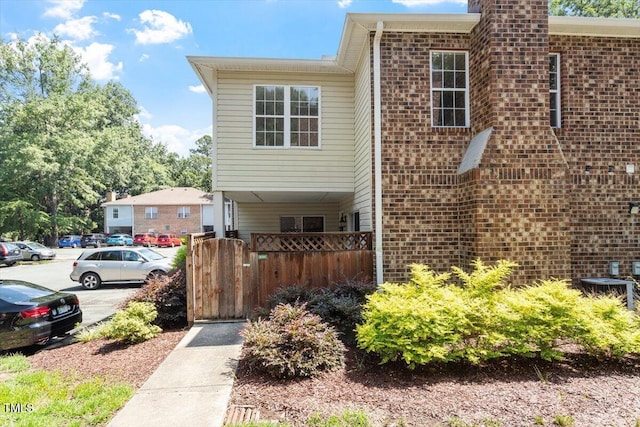 449 Summerwalk Cir, Chapel Hill, NC 27517 - view of front of property with brick siding, uncovered parking, and a chimney