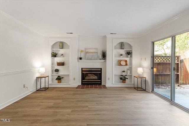 449 Summerwalk Cir, Chapel Hill, NC 27517 - living room featuring built in shelves, ornamental molding, a fireplace with flush hearth, and wood finished floors