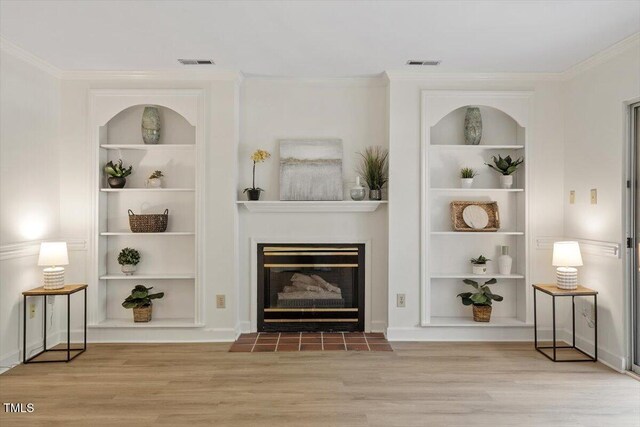 449 Summerwalk Cir, Chapel Hill, NC 27517 - unfurnished living room with built in shelves, wood finished floors, crown molding, and a fireplace with flush hearth