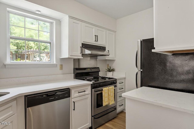 449 Summerwalk Cir, Chapel Hill, NC 27517 - kitchen featuring appliances with stainless steel finishes, under cabinet range hood, white cabinetry, and light wood-style floors