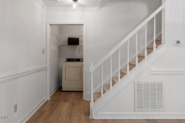 449 Summerwalk Cir, Chapel Hill, NC 27517 - stairs featuring washer / dryer, wood finished floors, and ornamental molding