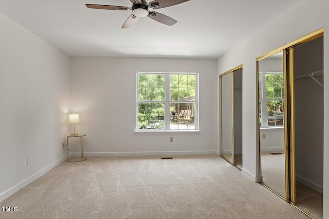 449 Summerwalk Cir, Chapel Hill, NC 27517 - unfurnished bedroom with two closets, carpet, and multiple windows
