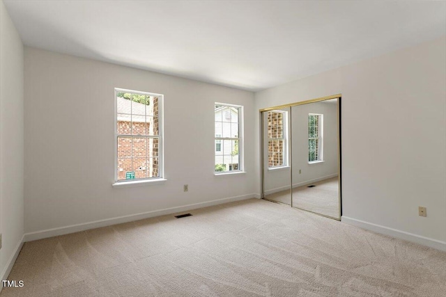 449 Summerwalk Cir, Chapel Hill, NC 27517 - unfurnished bedroom featuring multiple windows, carpet flooring, and a closet