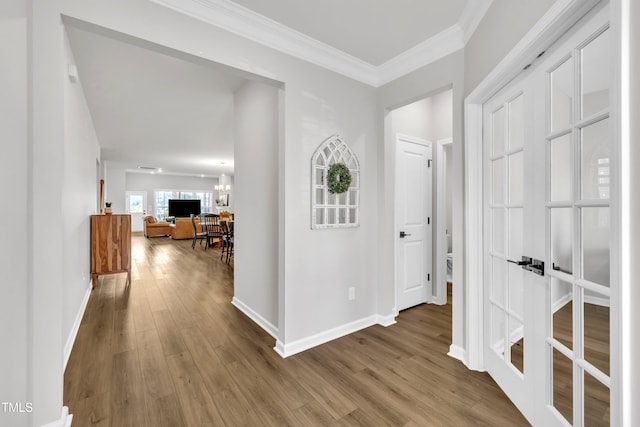 115 Circle City Way, Pittsboro, NC 27312 - corridor with wood finished floors, ornamental molding, and a chandelier