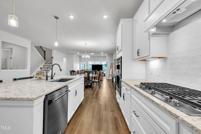 115 Circle City Way, Pittsboro, NC 27312 - kitchen with stainless steel appliances, range hood, tasteful backsplash, wood finished floors, and white cabinets
