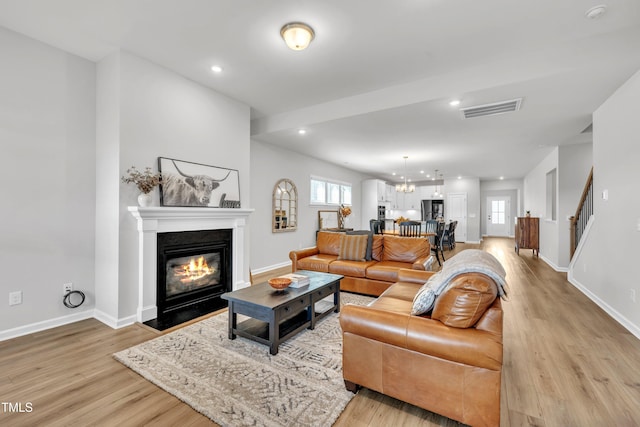 115 Circle City Way, Pittsboro, NC 27312 - living room with light wood finished floors, a fireplace with flush hearth, and recessed lighting