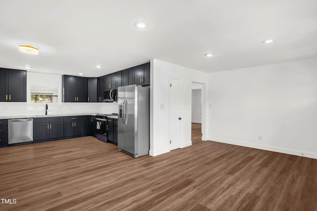 1907 Wilkins St, Burlington, NC 27217 - kitchen with stainless steel appliances, wood finished floors, recessed lighting, light countertops, and open floor plan