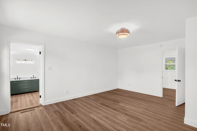 1907 Wilkins St, Burlington, NC 27217 - unfurnished room with wood finished floors and a sink