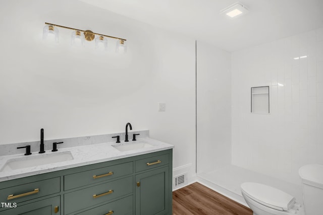 1907 Wilkins St, Burlington, NC 27217 - bathroom with walk in shower, double vanity, and wood finished floors