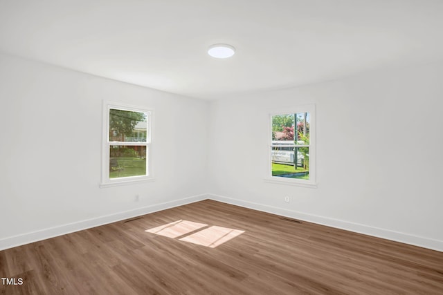 1907 Wilkins St, Burlington, NC 27217 - unfurnished room featuring wood finished floors and healthy amount of natural light
