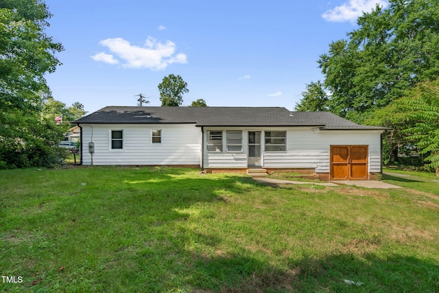 1907 Wilkins St, Burlington, NC 27217 - back of house with entry steps, a lawn, and a shingled roof