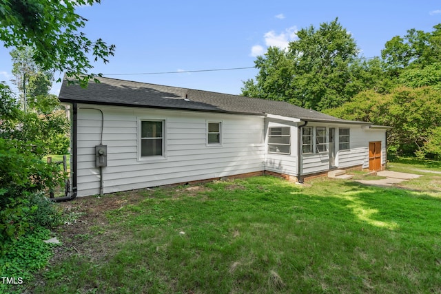 1907 Wilkins St, Burlington, NC 27217 - rear view of house with a yard and a shingled roof